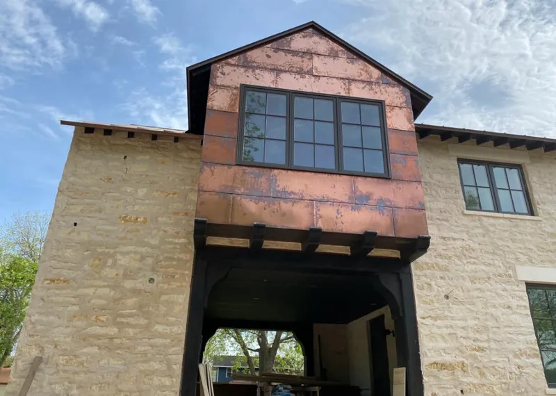 Copper metal panel facade on a stone building for Roof Repair in Valley Center